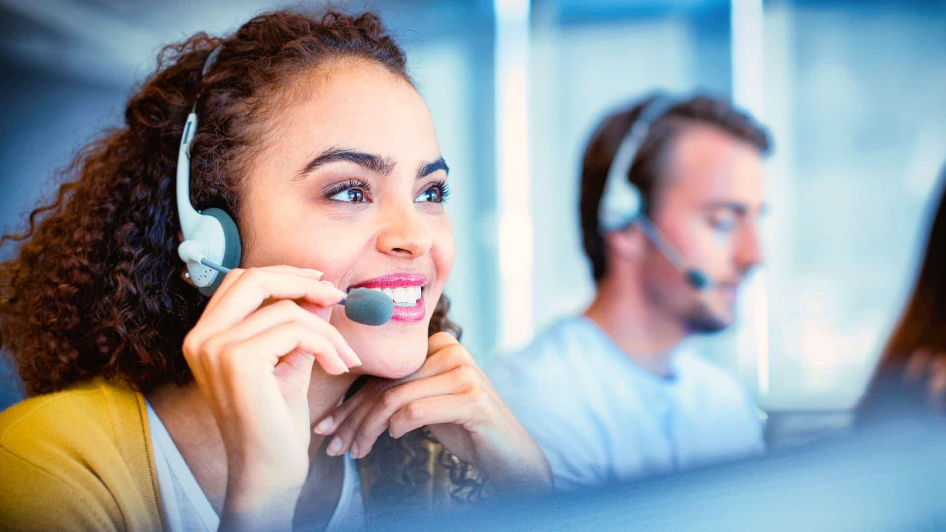 a woman talks on a headset